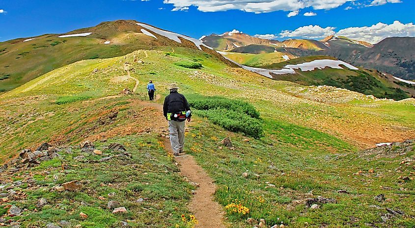 Hikers walking along the Continental Divide above 12,000 feet near Colorado's Loveland Pass.