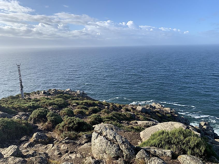 A tip of a rocky North Atlantic cape. The ocean looms large towards the horizon.