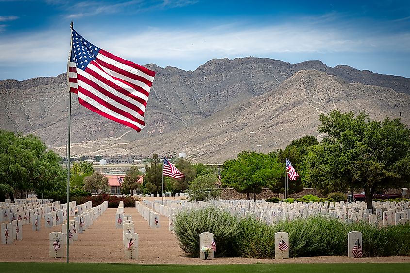A sunny Memorial Day with flags flying on graves of American service members at Fort Bliss National Cemetery in El Paso, Texas.