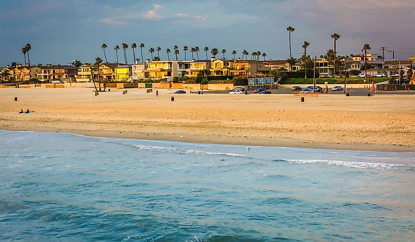 Waves in the Pacific Ocean and view of the beach at sunset in Seal Beach, California.