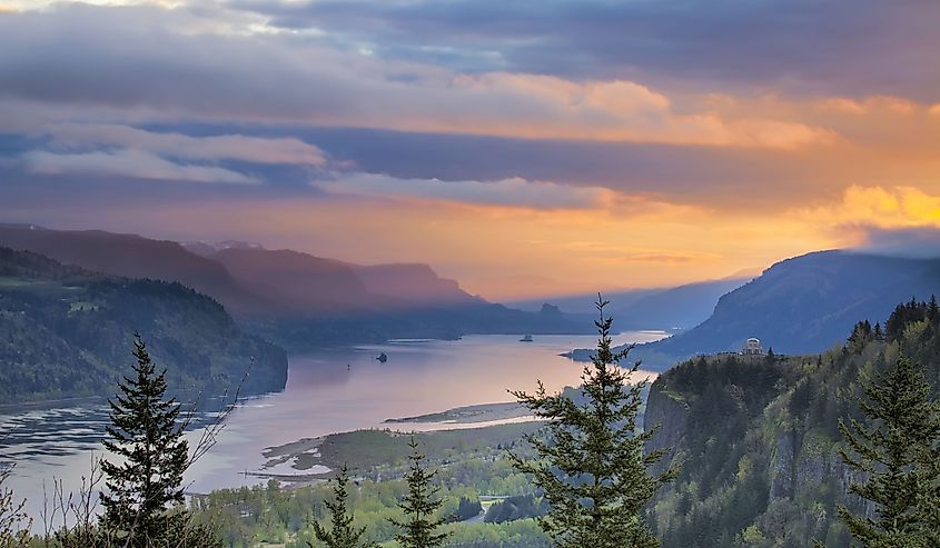 Crown Point and Vista House with rising sun over Columbia River Gorge.