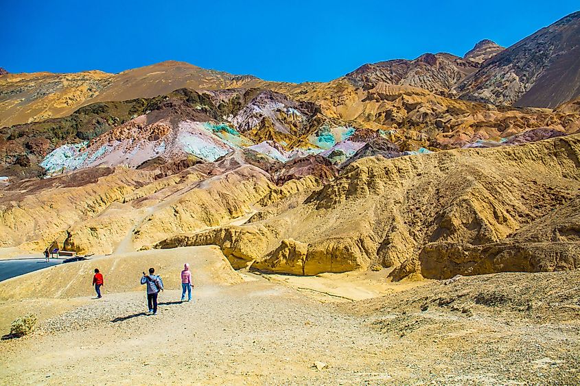 Tourists in Artist's Palette rocks on the mountain side in Death Valley National Park, California