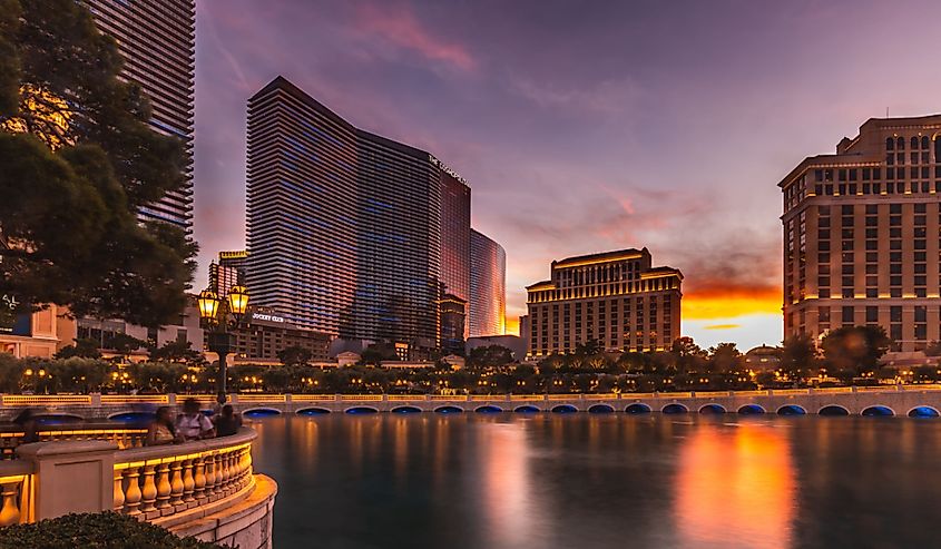 Fountains of Bellagio hotel with bright lights of hotels on Las Vegas Strip in Paradise, Nevada.