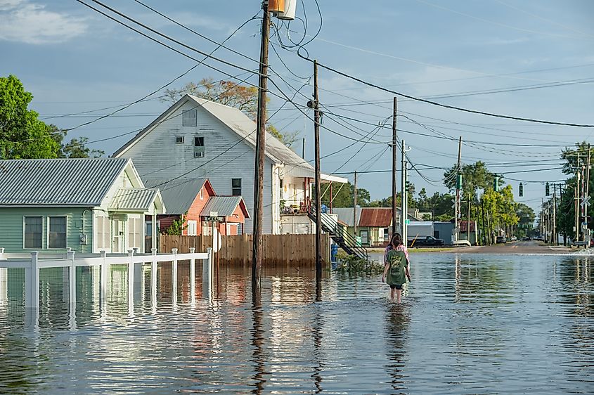 Flooded Canal Street in Delcambre, Iberia Parish, Louisiana, as two people walk along water-covered roads during Hurricane Laura