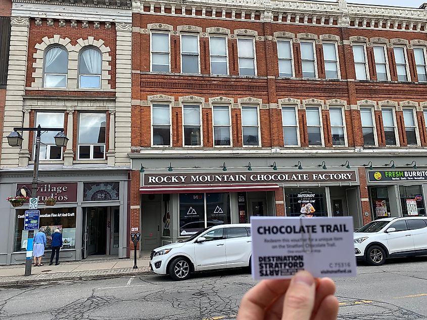 A POV shot of a Chocolate Trail ticket outside of the Rocky Mountain Chocolate Factory