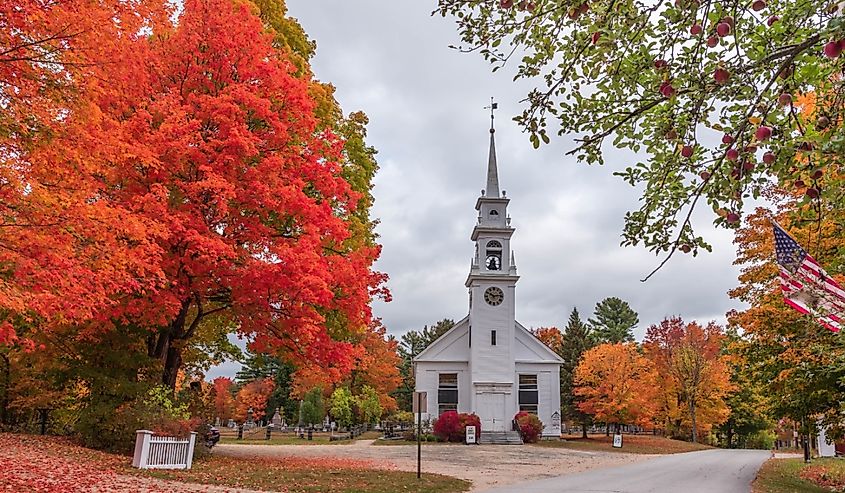 A beautiful shot of the Sandwich new Hampshire church surrounded by autumn trees