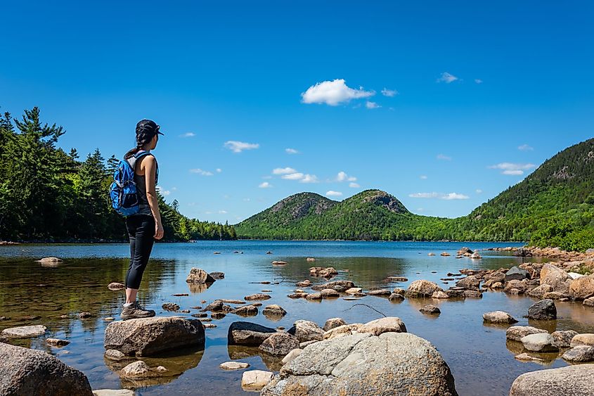 A female hiker at Jordan Pond in Acadia National Park, Maine. 