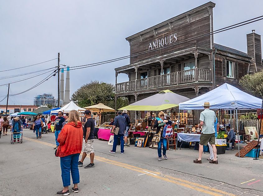 People enjoy the afternoon at the Moss Landing Street Fair, with food vendors and about 200 booths including antiques, collectibles and vintage memorabilia, via David A. Litman/ Shutterstock