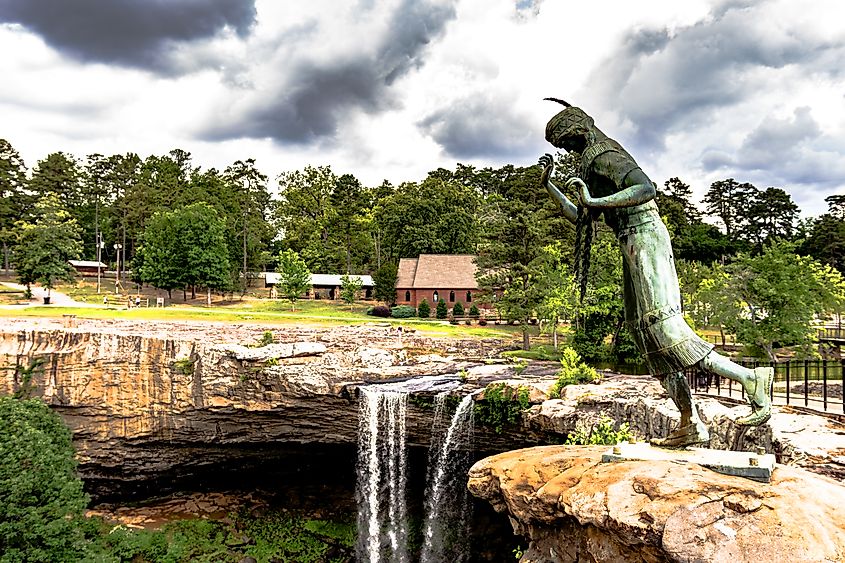 View of a statue of Noccalula in front of Noccalula Falls in Gadsden, Alabama. Editorial credit: JNix / Shutterstock.com