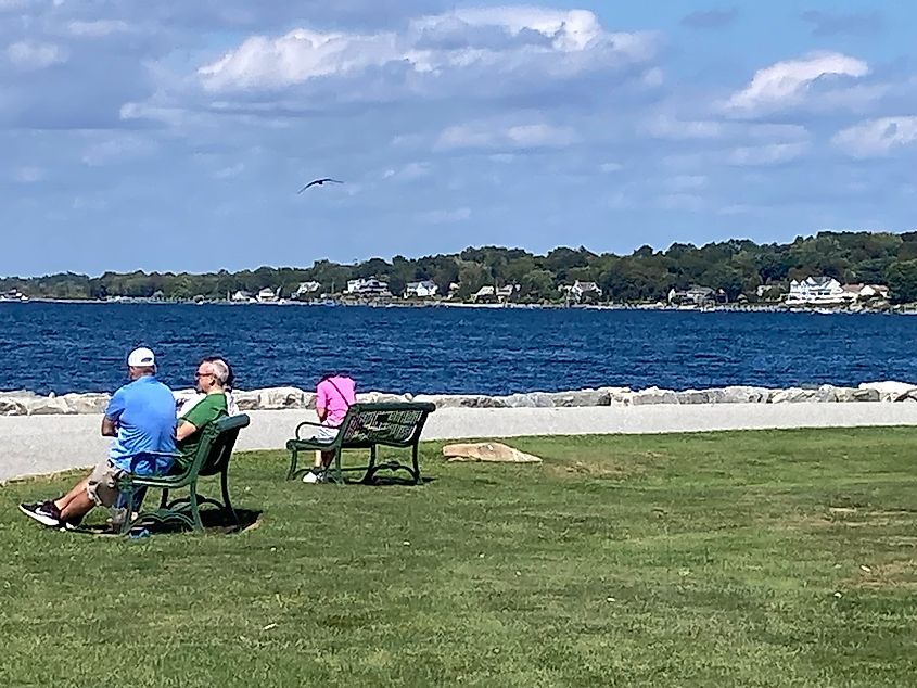 An elderly couple enjoying a relaxing time by the sea in Bristol, Rhode Island. Arthur D'Amario III / Shutterstock.com