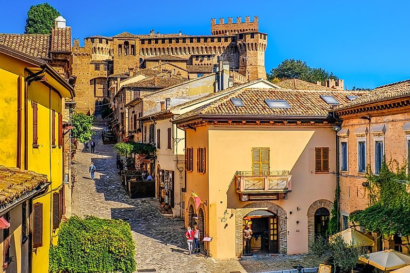 Medieval town buildings in Gradara, Italy, with colorful houses lining the village streets.