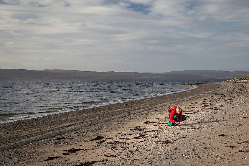 Beach combing on Arran Scotland. Credit: Searching For Satori / Shutterstock.com