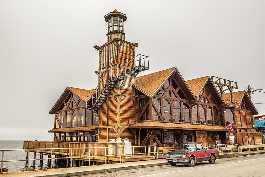 The Sea Breeze Restaurant with a historic lighthouse in downtown Cedar Key, Nick Fox / Shutterstock.com