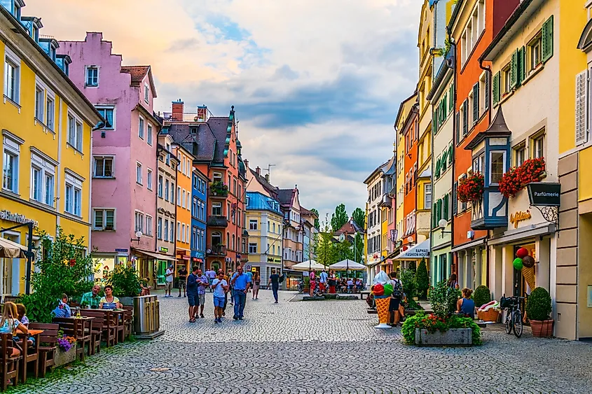 People are strolling through the main street in Lindau, Germany.