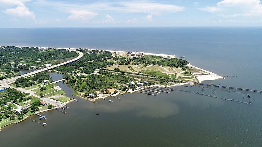 Scenic view of St. Louis Bay shoreline with piers and a river running through the town.