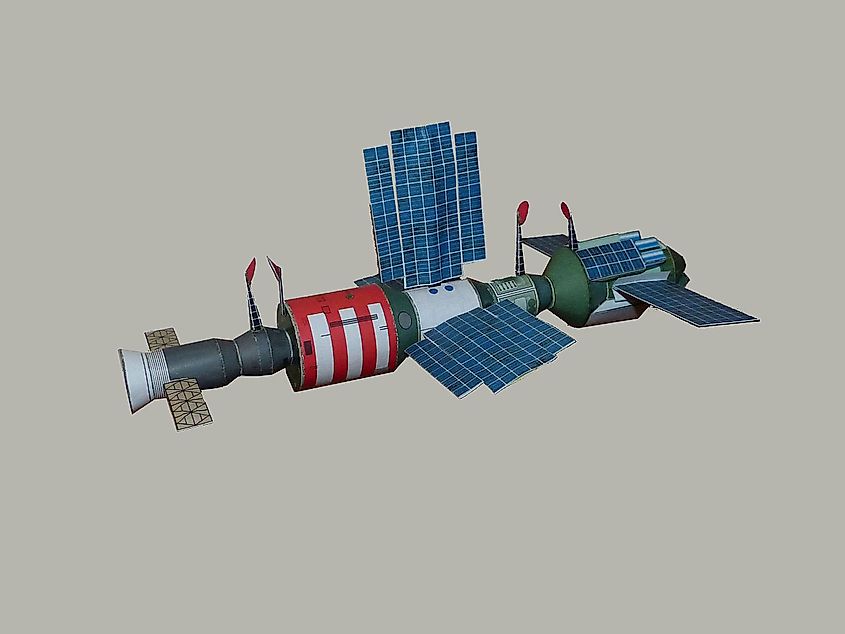 A paper model of a Salyut space station with spacecraft docked.