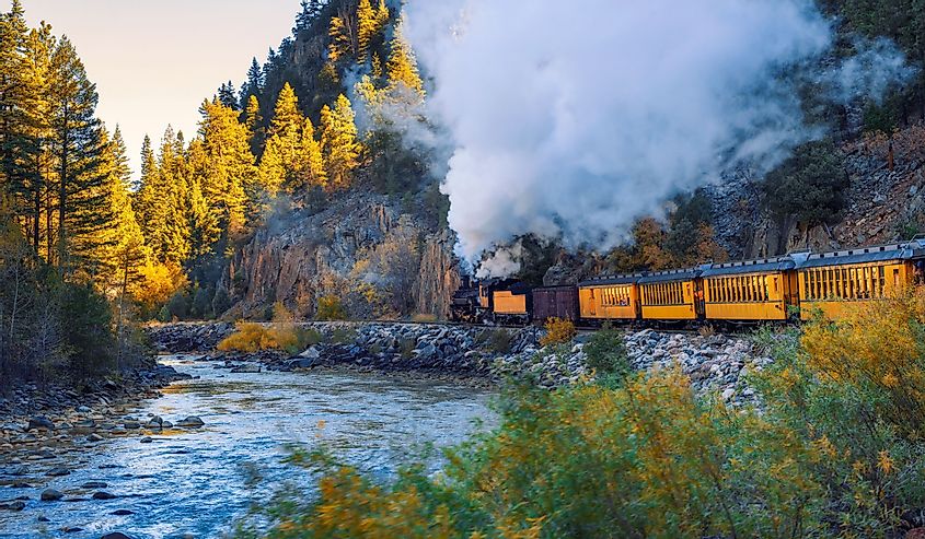 Historic steam engine train travels from Durango to Silverton through the San Juan Mountains along the Animas River in Colorado