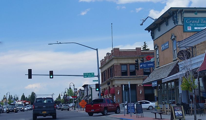 Street view with quaint buildings and cars traveling in Driggs, Idaho.