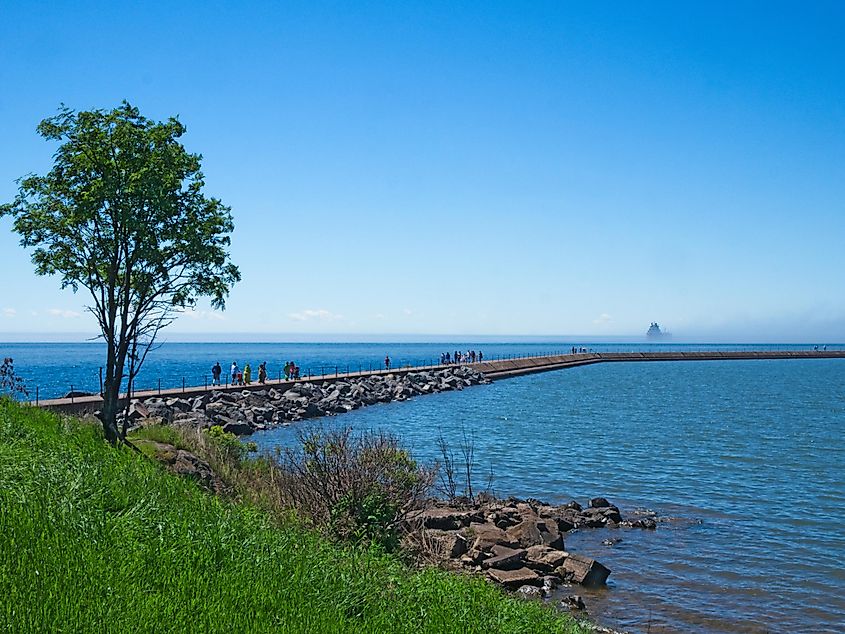 People on jetty at Two Harbors, Minnesota, on a sunny day.