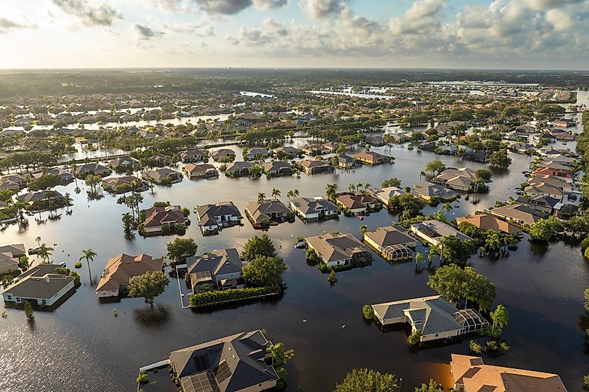 Flooded homes in a Florida residential community after hurricane rainfall, showing standing water and storm damage