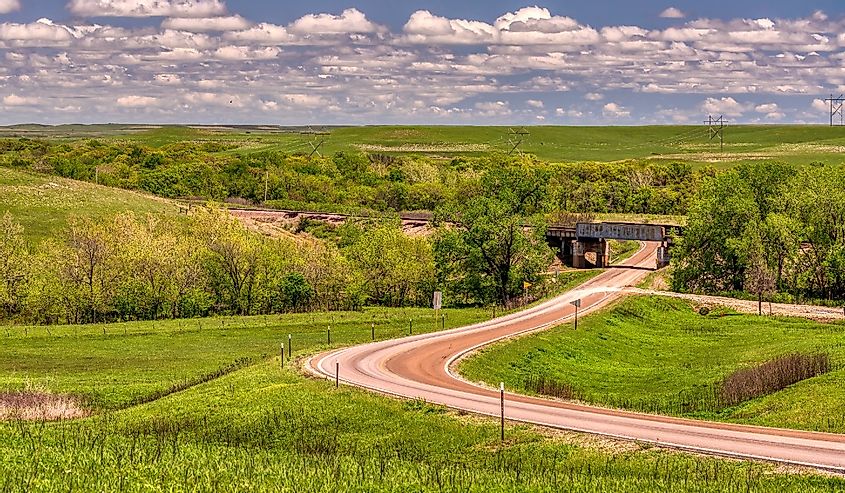 Road through the green pasture land in the Flint Hills of Kansas