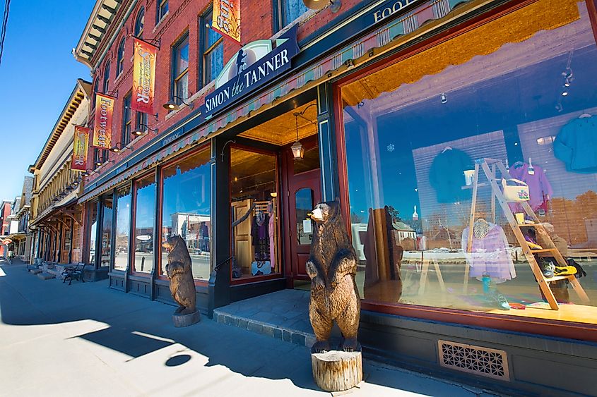 LANCASTER, NEW HAMPSHIRE / USA - MARCH 26, 2018: Bear sculptures stand next to historic buildings of a commercial block on Main Street.