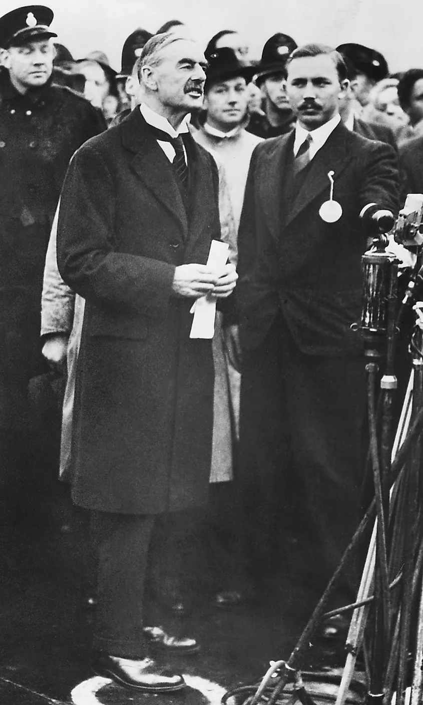 Neville Chamberlain declaring "peace in our time" after the supposed triumph at the Munich Conference.