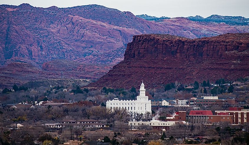 White temple and red rock mountains in St. George, Utah, USA. The white "Mormon" Temple stands out in stark contrast to the beautiful red rock mountains in southern Utah.