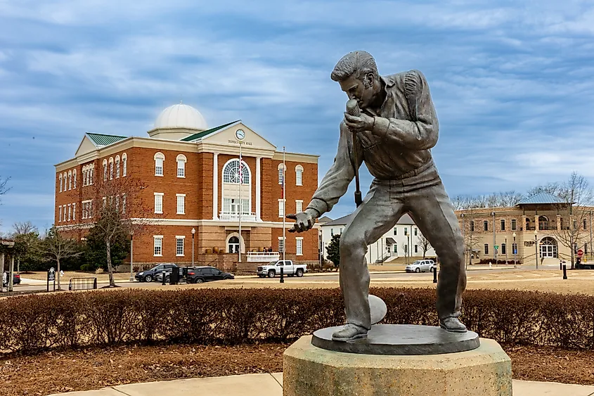 Elvis Presley Statue in Tupelo, MS, with City Hall in the background.