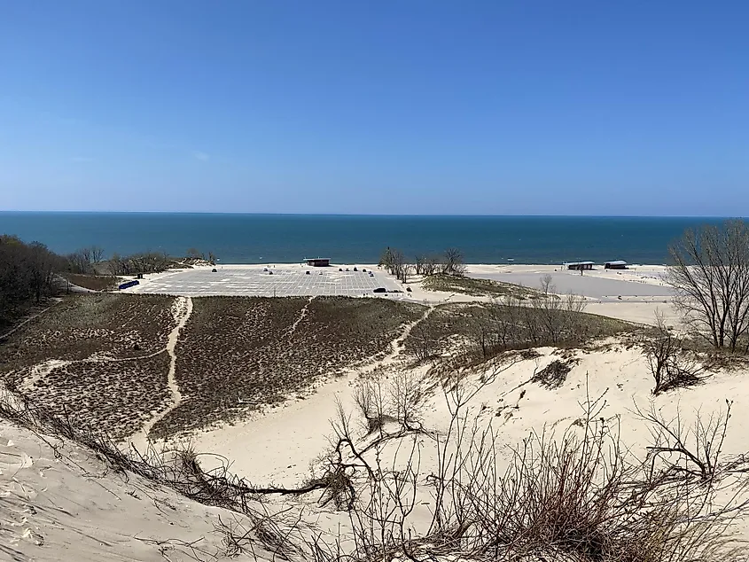 Empty beach parking lots as seen from the dunes above. A bluebird spring day