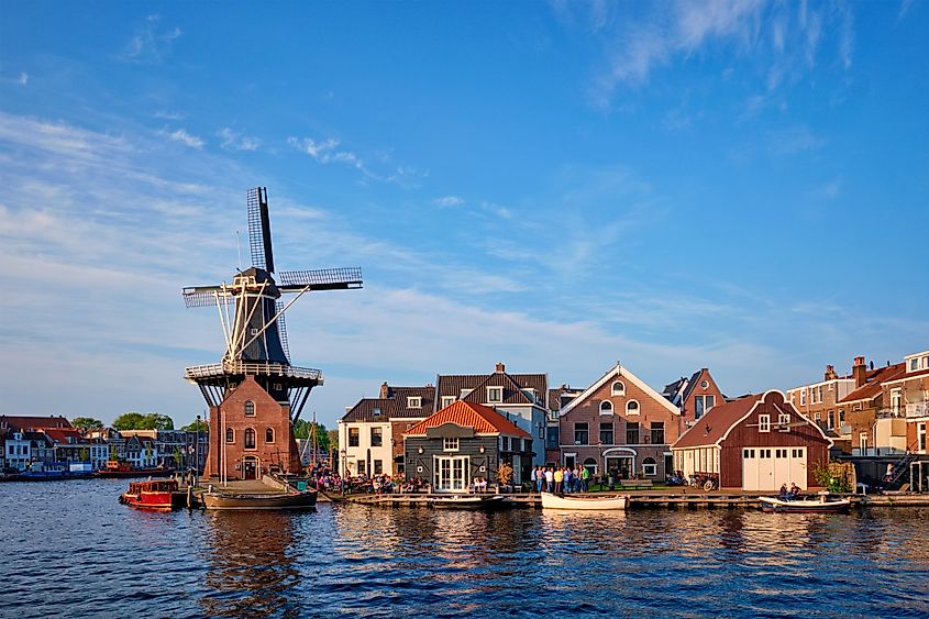 Haarlem cityscape, including the landmark windmill De Adriaan on the Spaarne river with boats. Haarlem, Netherlands