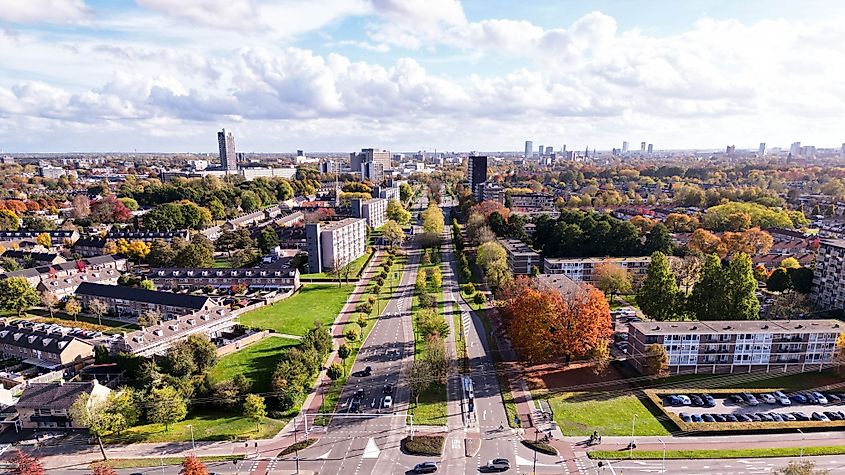 Aerial view of urban Eindhoven cityscape, featuring multiple buildings and trees.