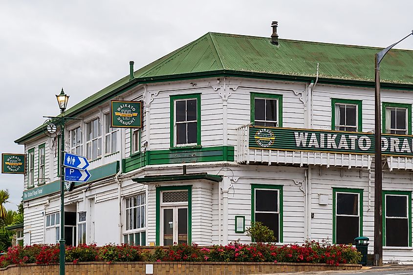 A vintage white and green hotel building in Tirau, New Zealand.