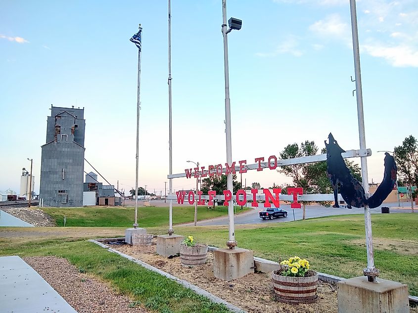 Welcome sign at railroad crossing next to the Amtrak Station in Wolf Point, Montana.