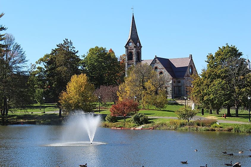 Amherst, Massachusetts / U.S.A. - October 10, 2016: University of Massachusetts Campus Pond with Old Chapel in the Background - Fall Day. Grandview Graphics via Shutterstock