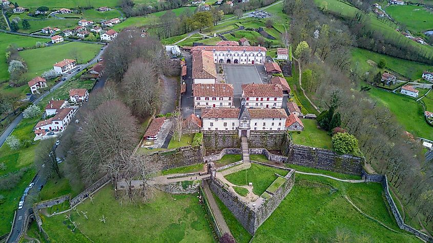 An aerial view of an old French fortress surrounded by green countryside