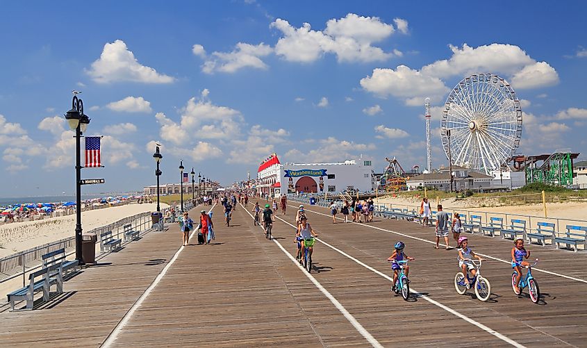 People walking and biking along the famous boardwalk in Ocean City, New Jersey