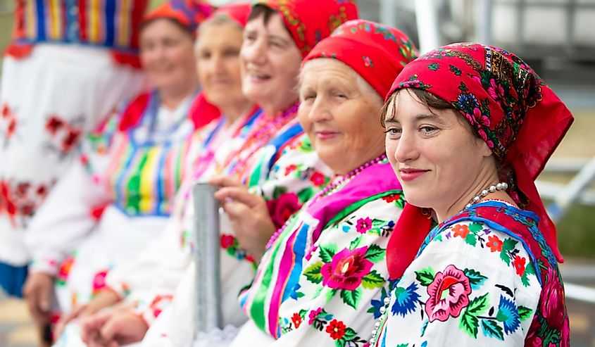 Belarusian women in ethnic embroidered shirts and scarves.