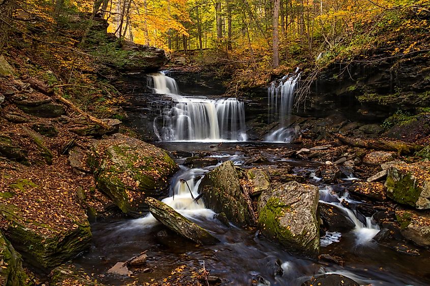 cascading waterfalls and autumn foliage trees in Ricketts Glenn in Pennsylvania.
