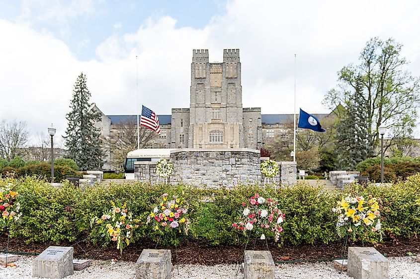 Historic Virginia Tech Polytechnic Institute and State University College campus with Burruss hall facade exterior and memorial flowers