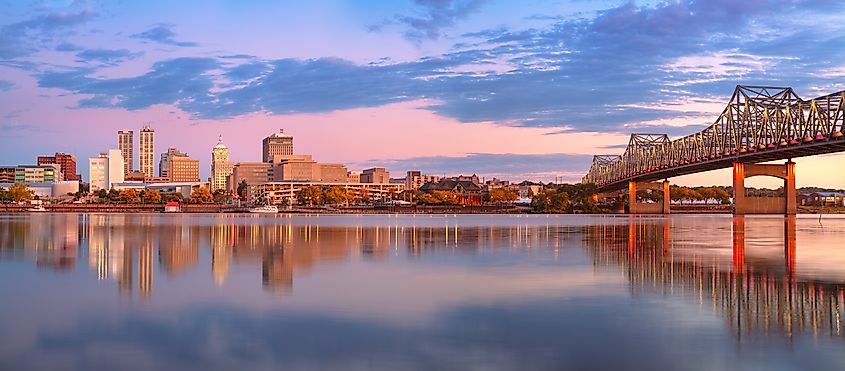 Peoria, Illinois, USA. Panoramic cityscape image of Peoria skyline, Illinois, USA with reflection of city lights in the Illinois River at autumn sunrise.