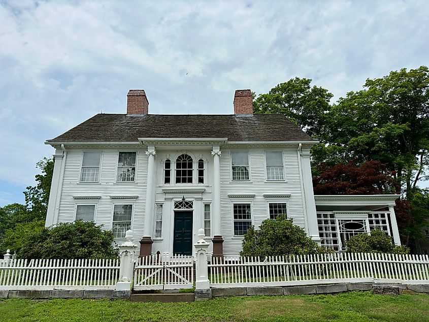 Chester, Connecticut, USA: Large, vintage white house with wooden, picket fence. Located on a hill. Unique, antique structure.
