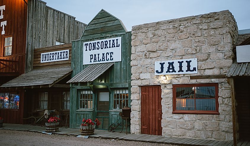Western village scene including "jail," "undertaker", Ogallala, Nebraska