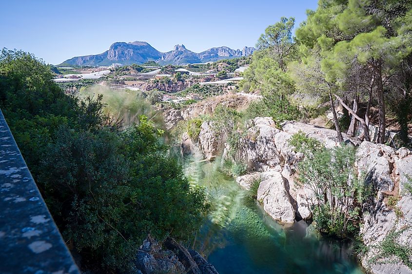 Waterfall and green water ponds in Las Fuentes del Algar Algar fountains, Callosa de Ensarria, Alicante province Spain. Credit: Sun Shock / Shutterstock