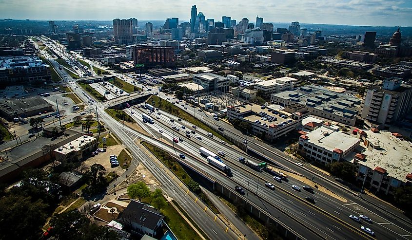 Aerial View over Austin Texas Interstate 35 busy traffic sunny day Capital City Cityscape Urban Skyline