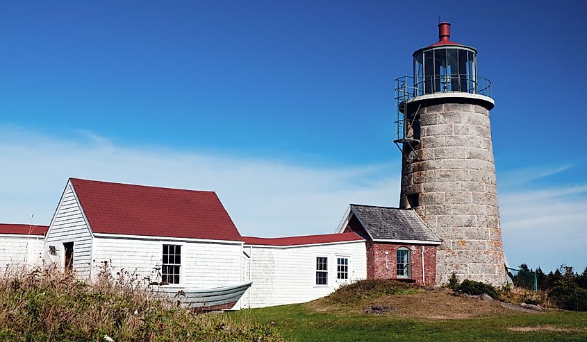 Monhegan Island lighthouse, with its stone tower, is situated on a hilltop