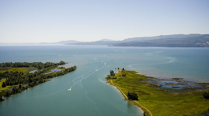 The Flathead River emptying into the north end of Flathead Lake at Bigfork, Montana, with the Salish Mountains in the distance.