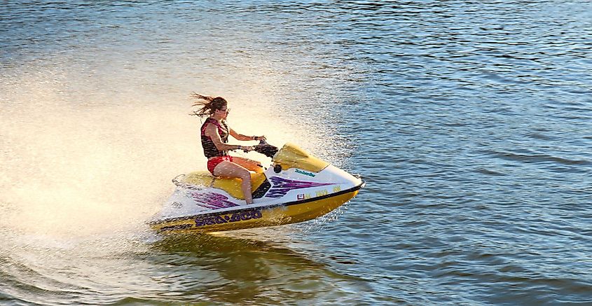 A woman riding a jetski in Saguaro Lake