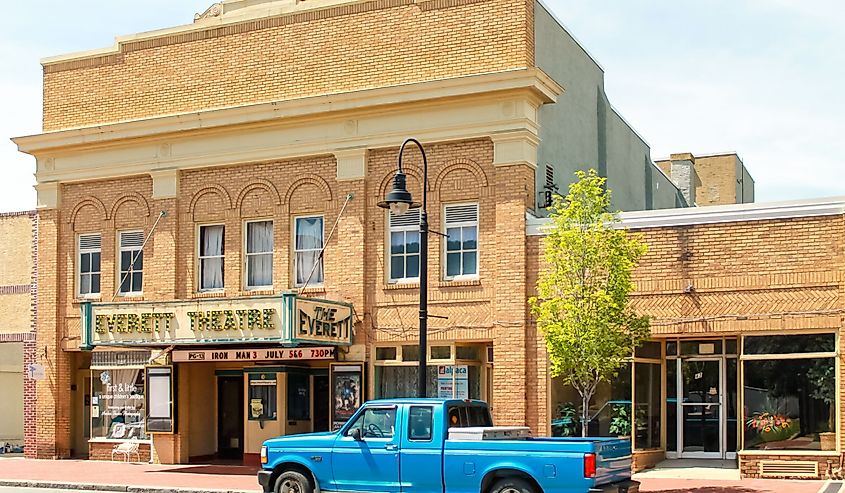 Blue pick-up truck on the street in front of the Everett Theatre