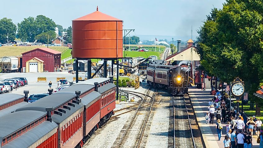 Strasburg, Pennsylvania, a vibrant train station filled with travelers and vintage locomotives.